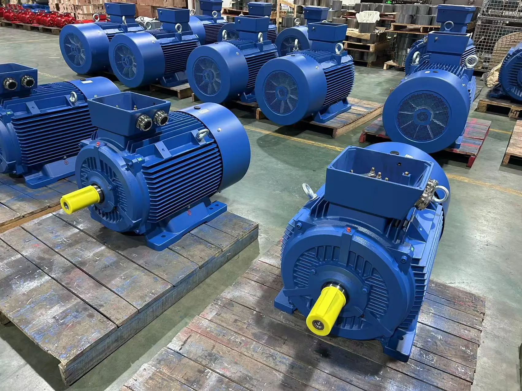 An engineer inspecting an induction motor with a caliper, focusing on quality control.