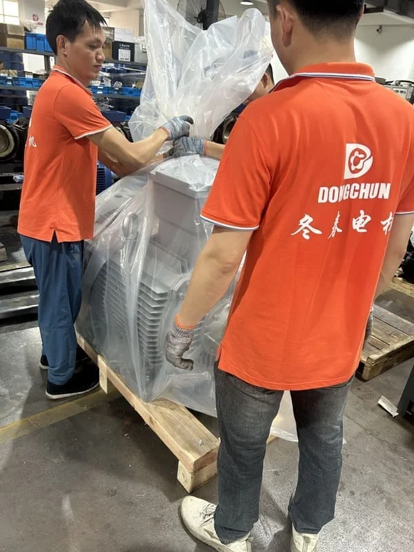 A person with a clipboard checking off items next to a new electric motor.